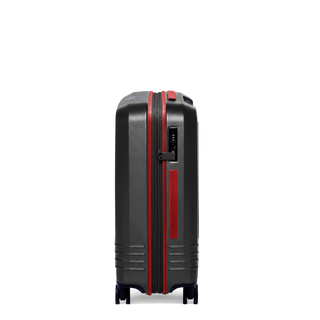 ROAM Matte Edit hardside expandable check-in suitcase in matte black with red trim, side view