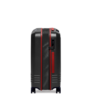ROAM Matte Edit hardside expandable check-in suitcase in matte black with red trim, side view, expanded