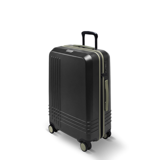 ROAM Matte Edit hardside check-in suitcase in matte black with green trim, three-quarter view