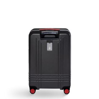 ROAM Matte Edit hardside check-in suitcase in matte black with red trim, back view