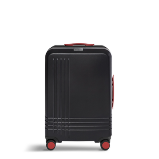 ROAM Matte Edit hardside check-in suitcase in matte black with red trim, front view