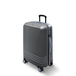 ROAM Matte Edit hardside check-in suitcase in matte steel with slate trim, three-quarter view