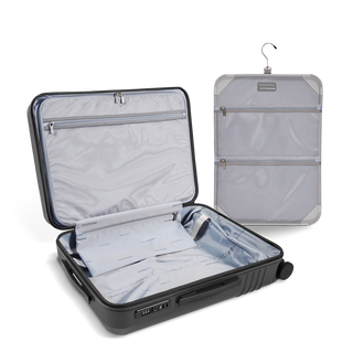 ROAM Matte Edit hardside check-in suitcase in matte steel, open, showing the empty interior and lining