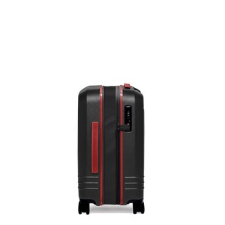 ROAM Matte Edit hardside expandable carry-on suitcase in matte black with red trim, side view, expanded