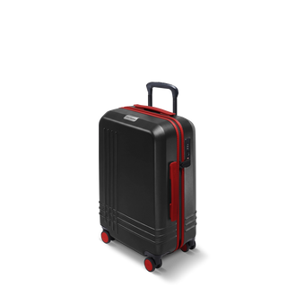 ROAM Matte Edit hardside carry-on suitcase in matte black with red trim, three-quarter view