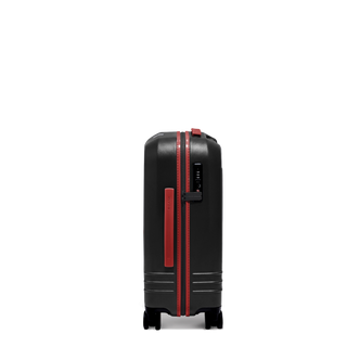 ROAM Matte Edit hardside carry-on suitcase in matte black with red trim, side view