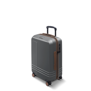 ROAM Matte Edit hardside carry-on suitcase in matte steel with saddle trim, three-quarter view