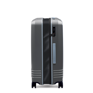 ROAM Matte Edit hardside expandable large check-in suitcase in matte steel with slate trim, side view, expanded