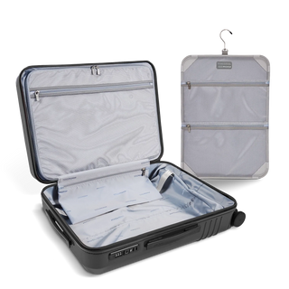 ROAM Matte Edit hardside expandable large check-in suitcase in matte steel, open, showing the empty interior and lining