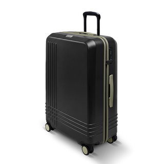 ROAM Matte Edit hardside large check-in suitcase in matte black with green trim, three-quarter view