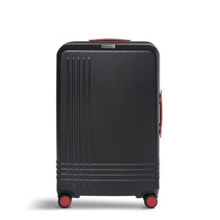 ROAM Matte Edit hardside large check-in suitcase in matte black with red trim, front view