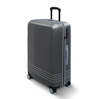 ROAM Matte Edit hardside large check-in suitcase in matte steel with slate trim, three-quarter view