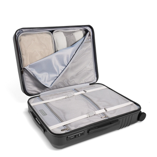 ROAM Matte Edit hardside large check-in suitcase in matte steel, open, showing the packed interior