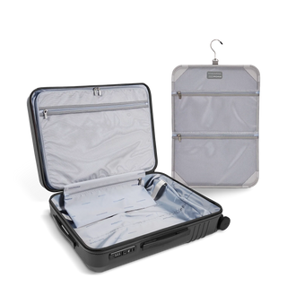 ROAM Matte Edit hardside expandable large carry-on suitcase in matte steel, open, showing the empty interior and lining