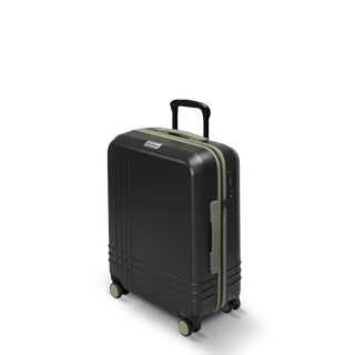 ROAM Matte Edit hardside large carry-on suitcase in matte black with green trim, three-quarter view
