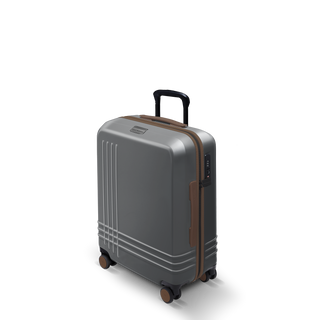ROAM Matte Edit hardside large carry-on suitcase in matte steel with saddle trim, three-quarter view