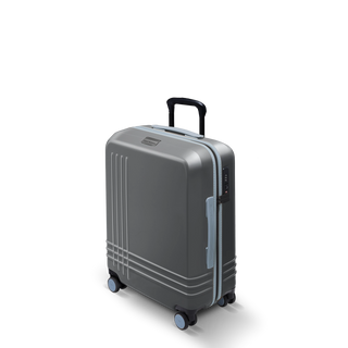ROAM Matte Edit hardside large carry-on suitcase in matte steel with slate trim, three-quarter view